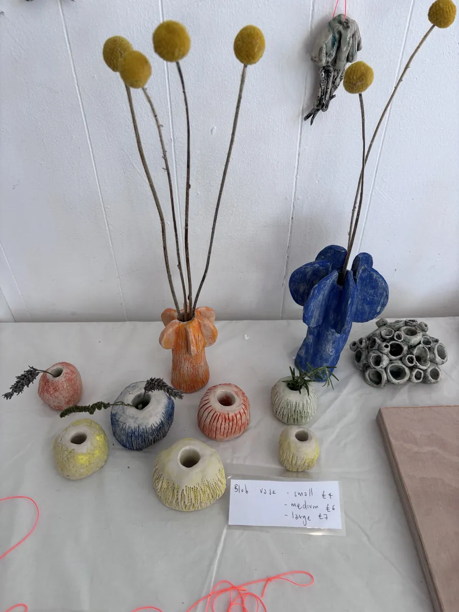Blob vases and two petal vases holding craspedia