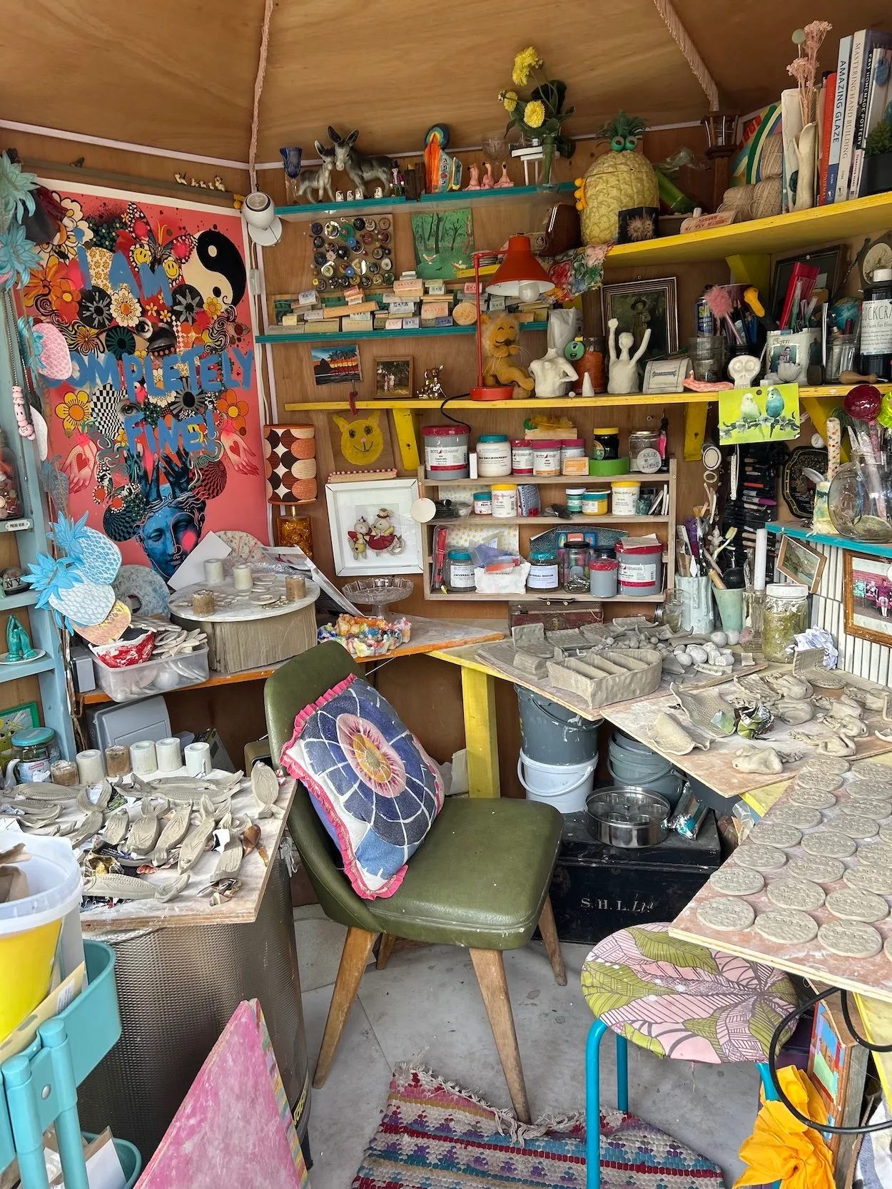 Gemma's colourful ceramics studio, shelves full of glazes and pieces in progress