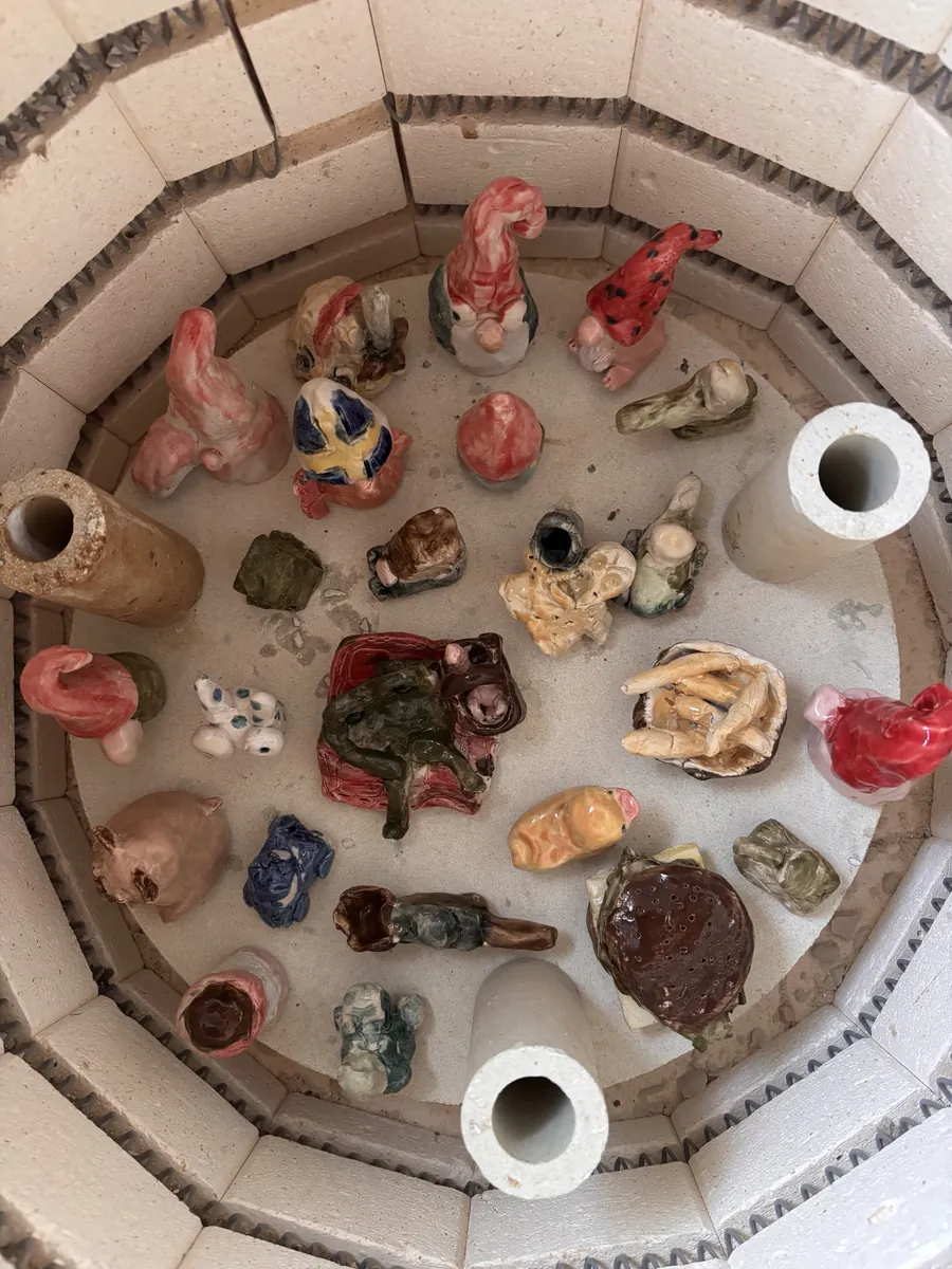 A kiln full of glazed gnomes, a burger, chips and little creatures