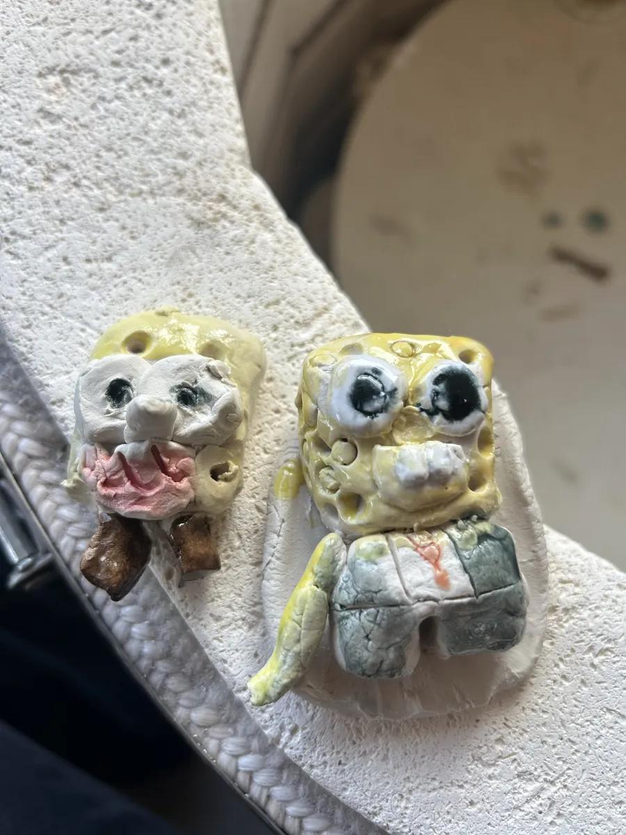 Two yellow cartoon sponge characters made in clay