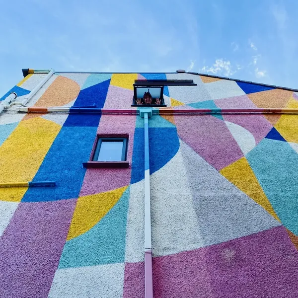 A house wall painted in bright geometric shapes
