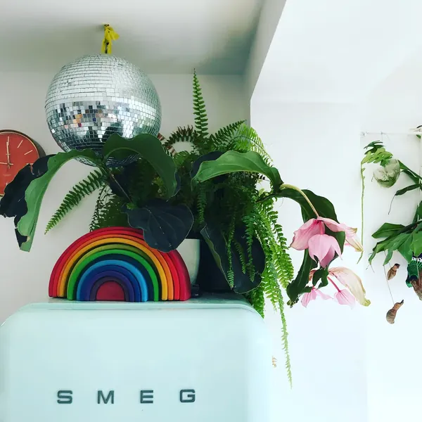 A kitchen corner with a mint Smeg fridge