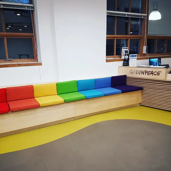 A bench with rainbow seat cushions