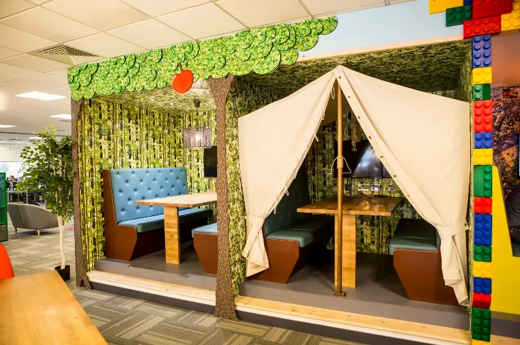 Buttoned booths inside a treehouse-themed office meeting den