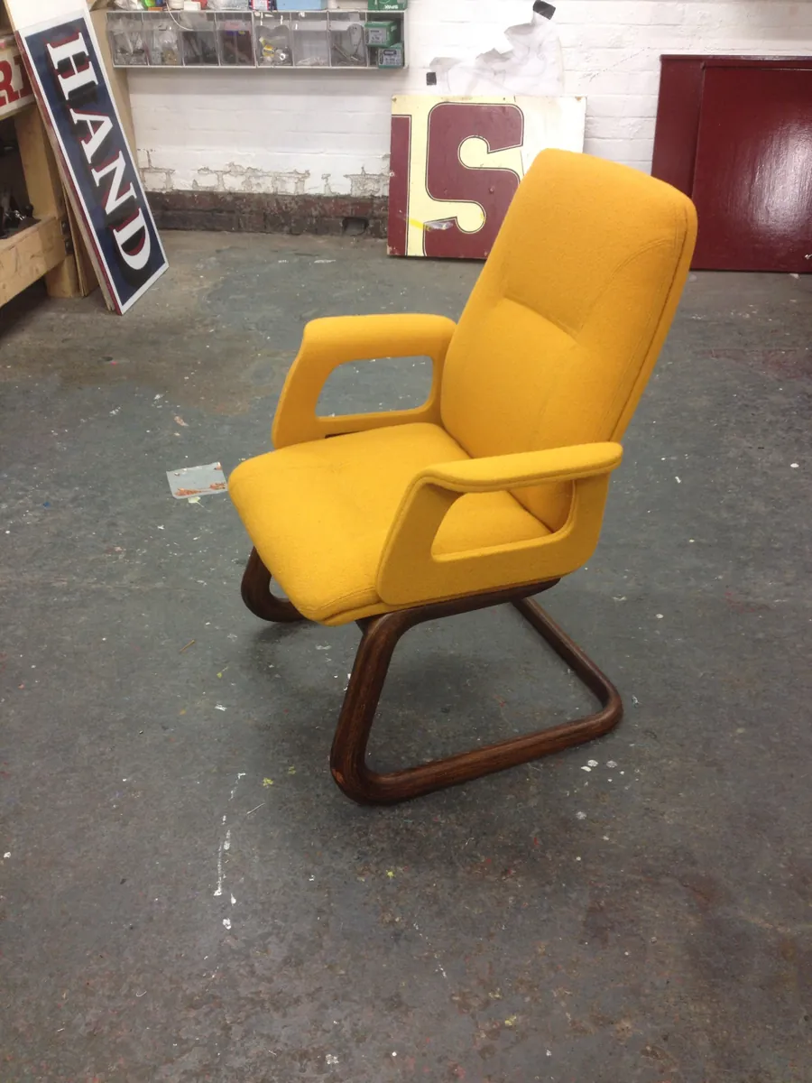 A retro armchair reupholstered in mustard wool on a bentwood base